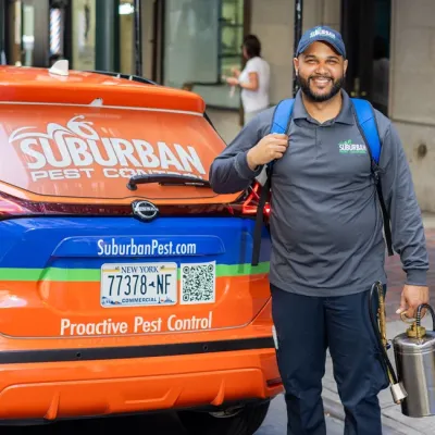 technician outside of company vehicle smiling