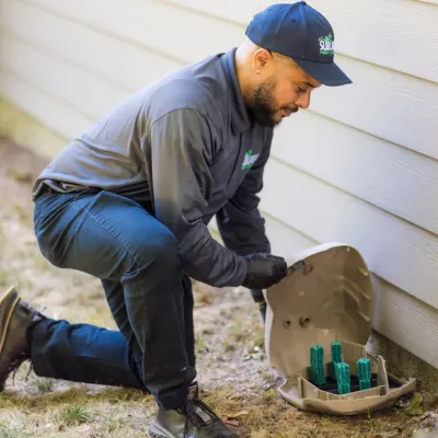 technician installing rodent bait station