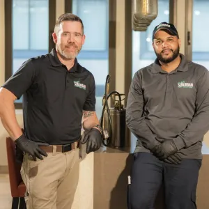 two technicians smiling