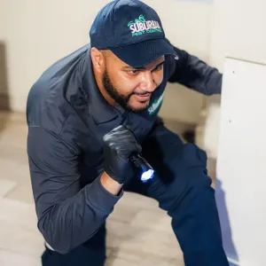 technician with flashlight doing a home inspection