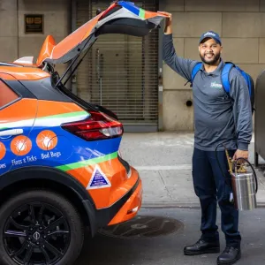 technician in the back of company vehicle with trunk open