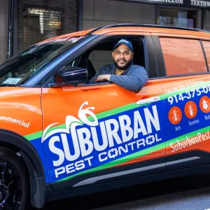 technician inside suburban pest company vehicle
