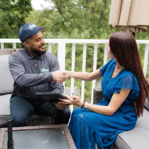 technician and customer shaking hands on outside patio