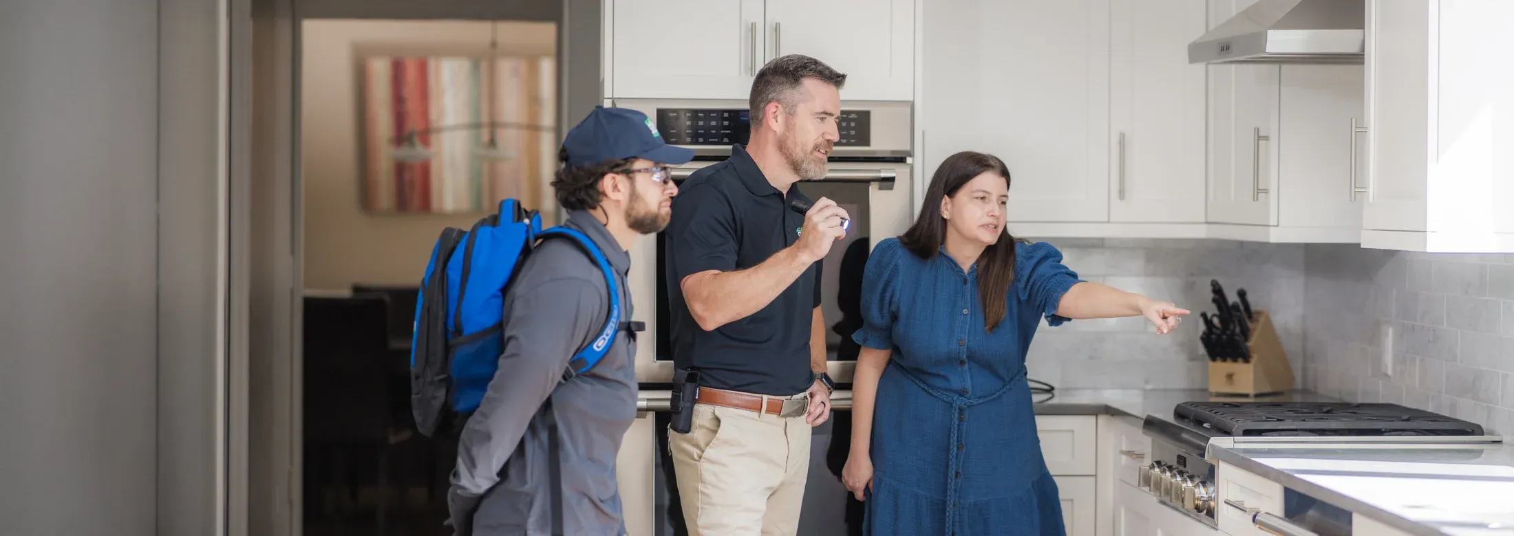 technicians speaking with customer inspecting home