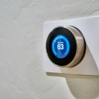 Digital thermostat on white wall
