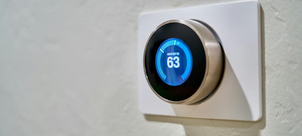 Digital thermostat on white wall