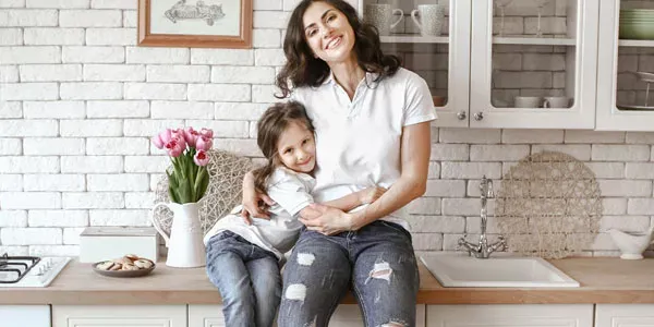 mom and daughter in kitchen laughing