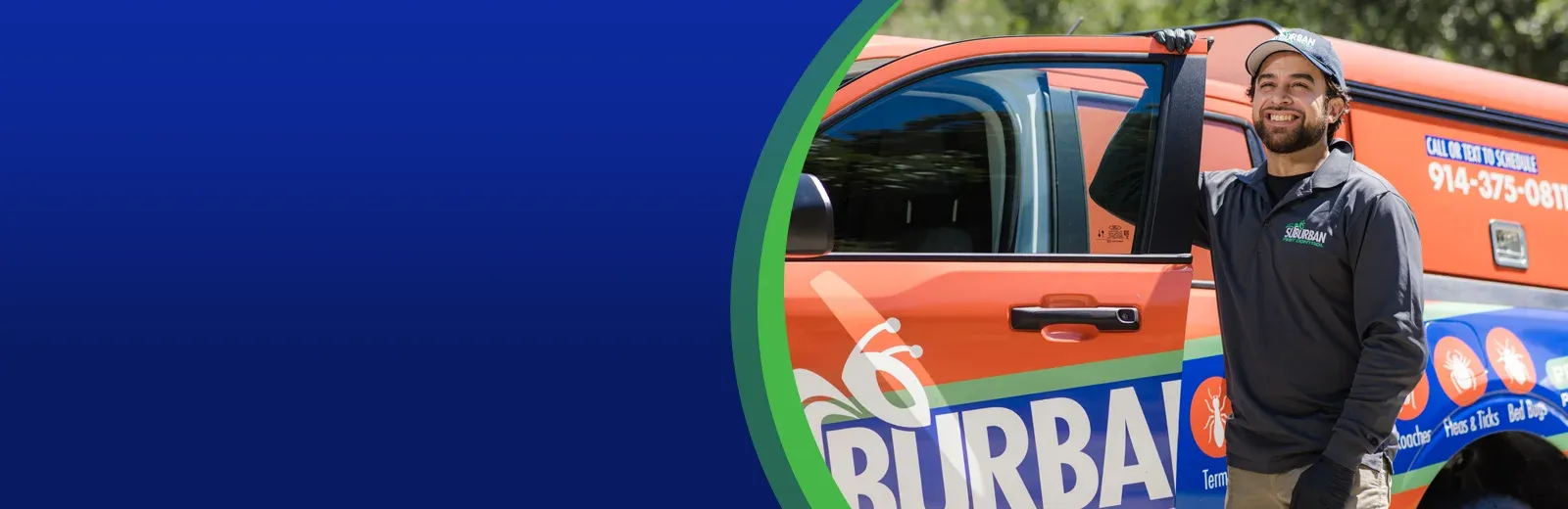 suburban pest technician outside company truck smiling